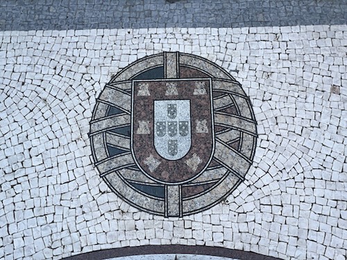 Cobblestone work depcting Portugal's coat of arm (the one from the Portuguese flag).