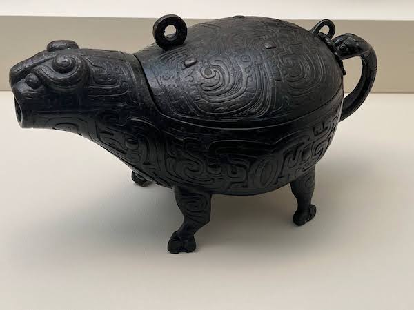 Picture of a bronze vessel in the shape of a animal (cow?).